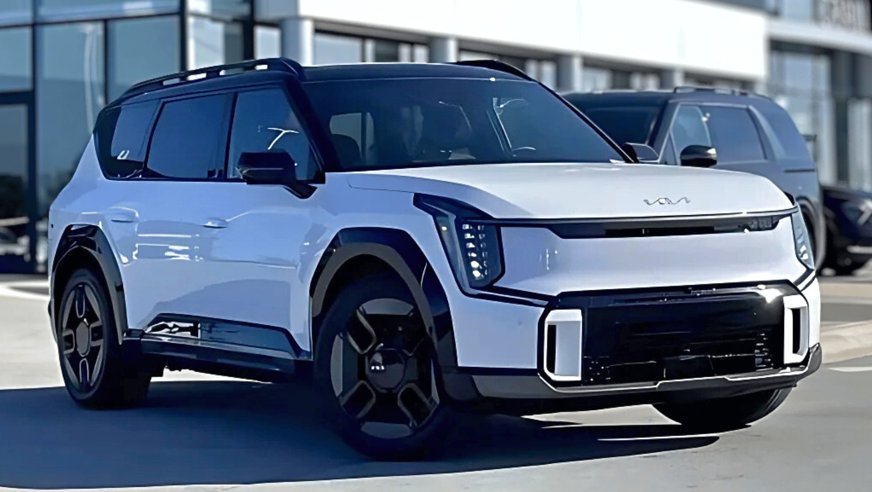 White 2026 EV9 electric three row in front of Crain Kia of Fayetteville